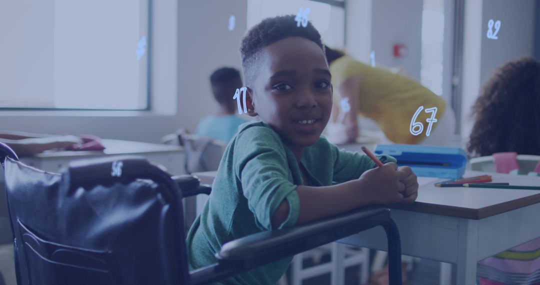 Happy Schoolboy in Wheelchair Learning in Classroom