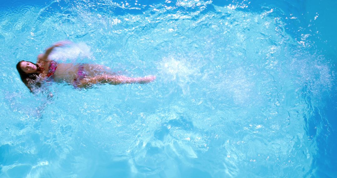 Woman Swimming Backstroke in Clear Blue Pool Water - Free Images, Stock Photos and Pictures on Pikwizard.com