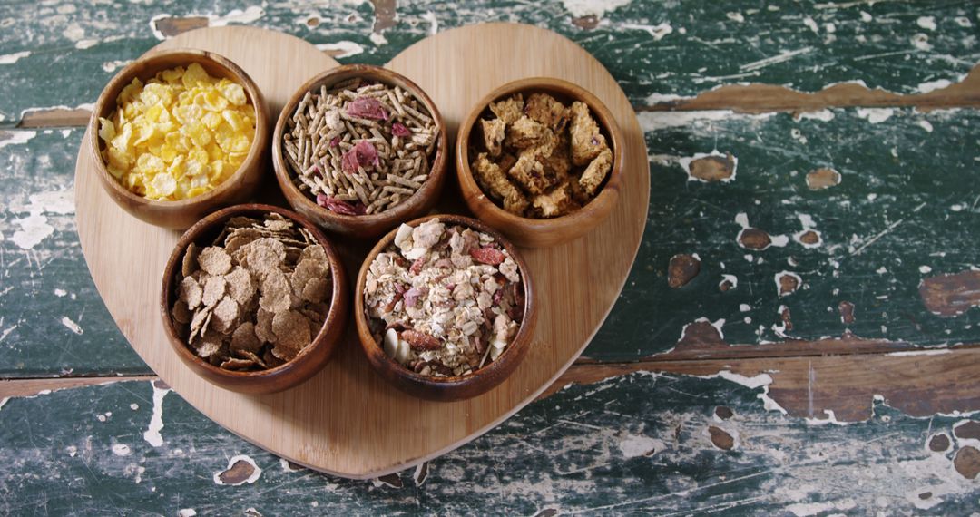 Assorted Healthy Cereals in Wooden Bowls on Heart-Shaped Board - Free Images, Stock Photos and Pictures on Pikwizard.com