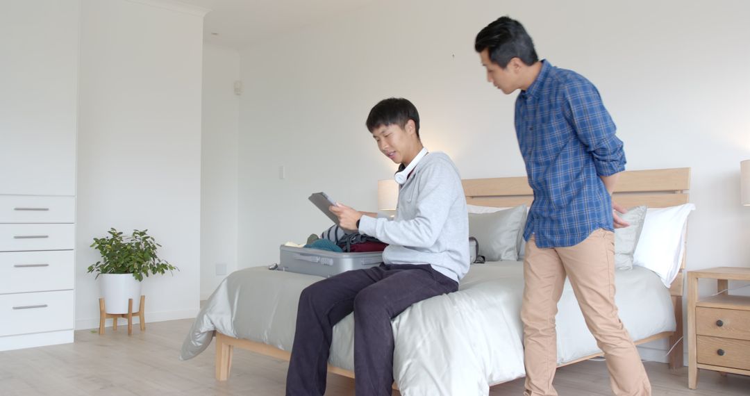 Father and Son Collaborating on Packing for Exciting Family Trip