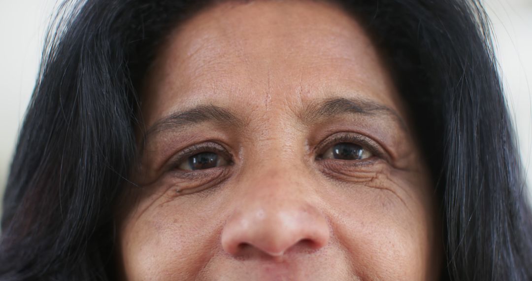 Close-Up of Middle-Aged Woman Smiling with Dark Hair - Free Images, Stock Photos and Pictures on Pikwizard.com