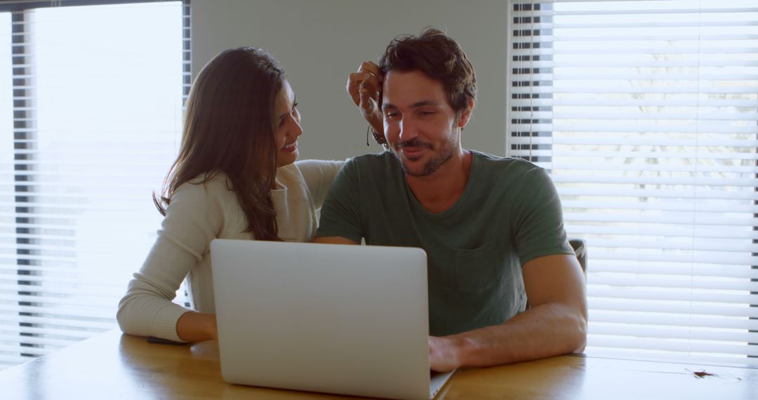 Couple Enjoying Technology Time Together at Home with Laptop