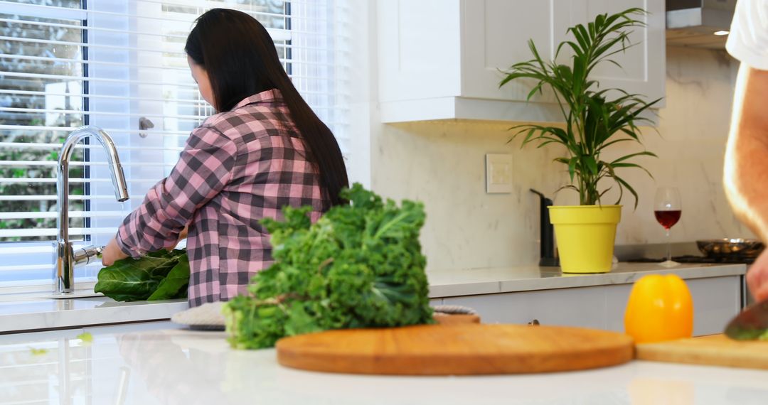 Woman Washing Vegetables in Modern Kitchen - Free Images, Stock Photos and Pictures on Pikwizard.com