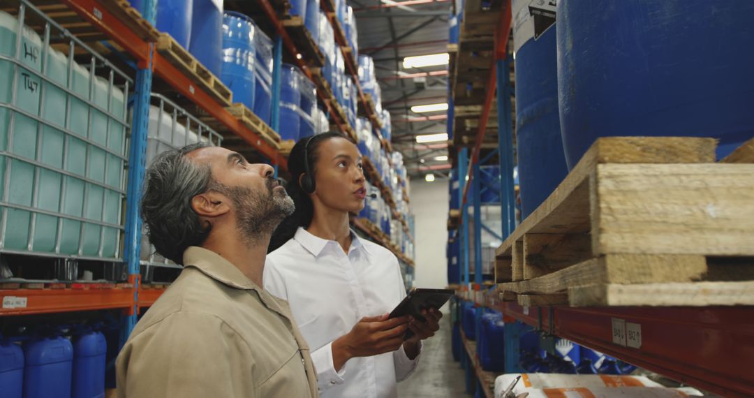 Warehouse Workers Inspecting Storage Shelves with Digital Tablet - Free Images, Stock Photos and Pictures on Pikwizard.com