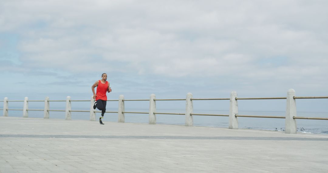 Man Jogging on Seaside Promenade for Outdoor Fitness - Free Images, Stock Photos and Pictures on Pikwizard.com