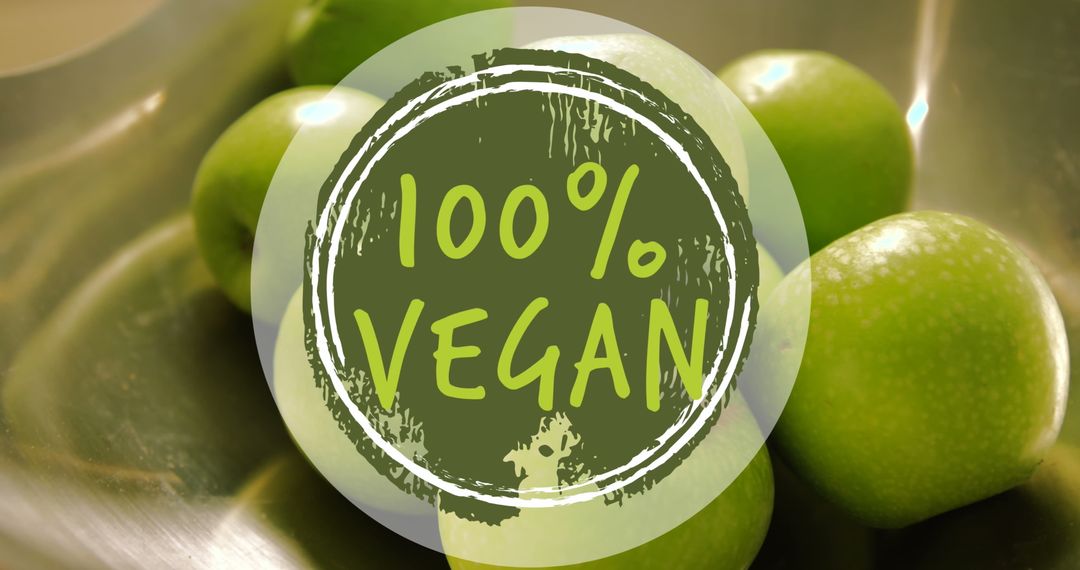 100% vegan label on fresh green apples