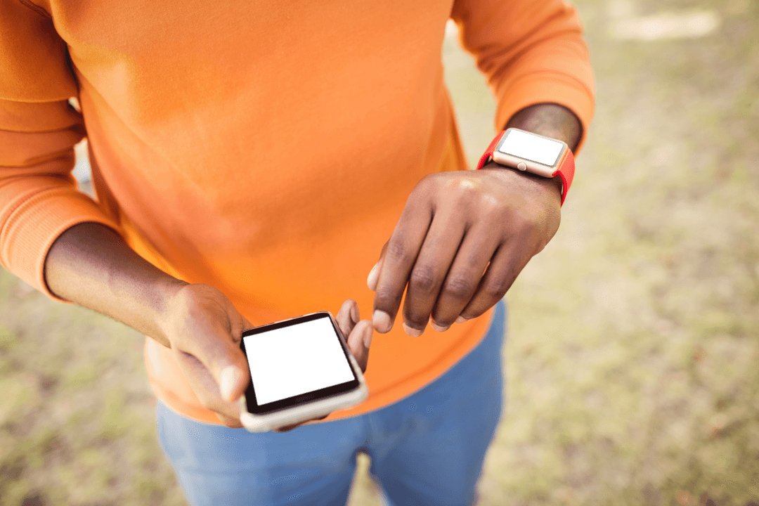 Man with Transparent Device Screens Wearing Orange in Open Field - Download Free Stock Images Pikwizard.com