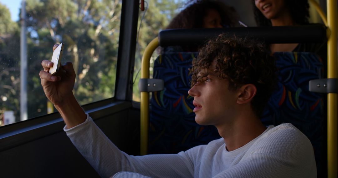 Young Man Taking Selfie on Bus During Daylight - Free Images, Stock Photos and Pictures on Pikwizard.com