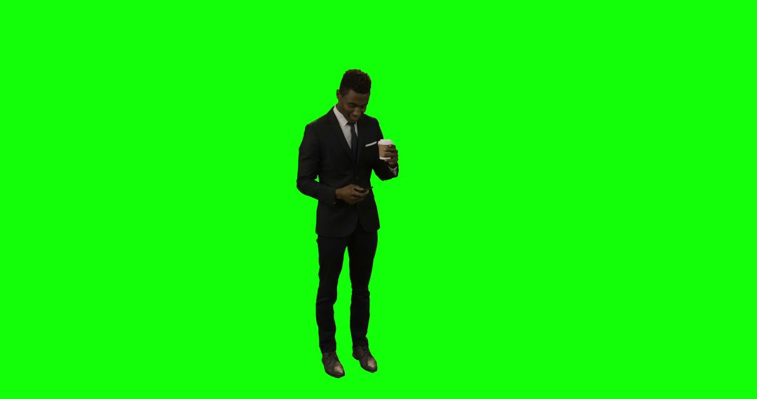 Businessman Checking Phone with Coffee on Green Background - Free Images, Stock Photos and Pictures on Pikwizard.com