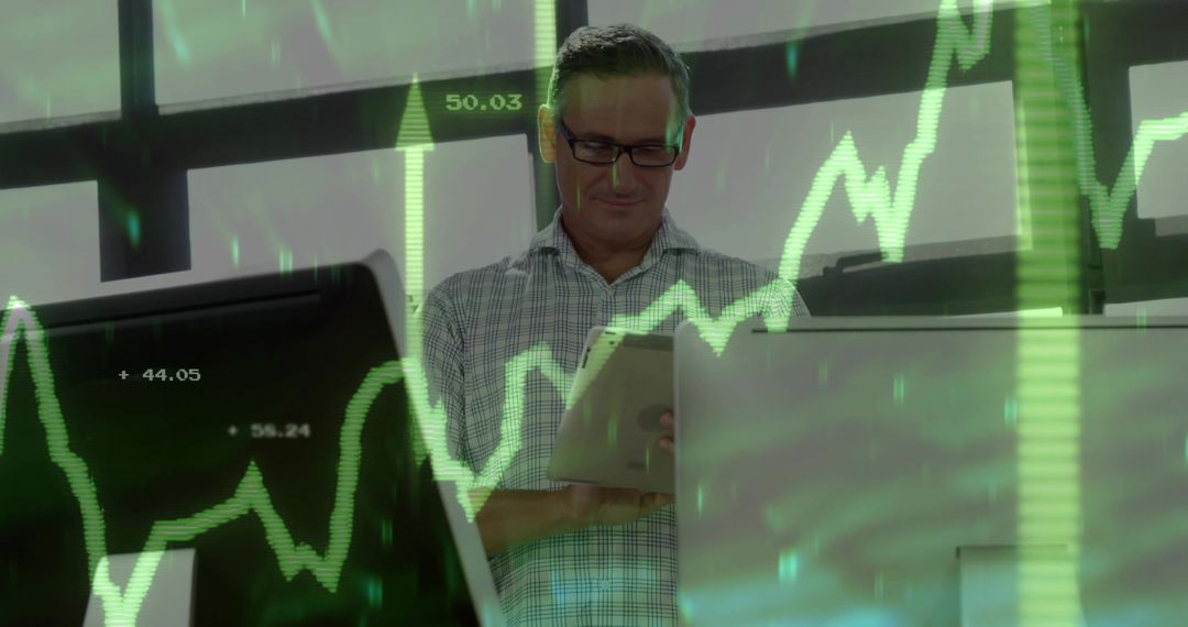 Senior Analyst Scanning Tablet Monitoring Green Stock Charts on Office Monitors
