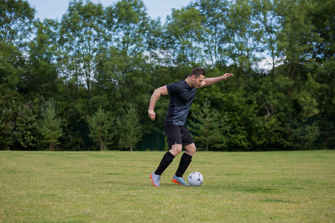 Athlete Controlling Soccer Ball on Grass Field