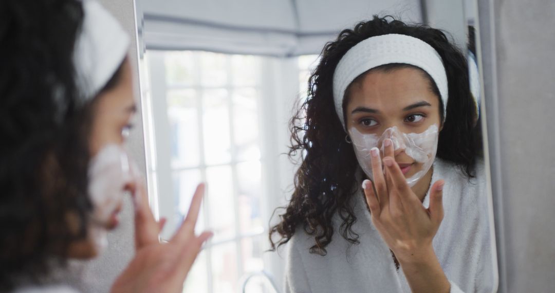 Woman Applying Skincare Mask in Front of Mirror - Free Images, Stock Photos and Pictures on Pikwizard.com