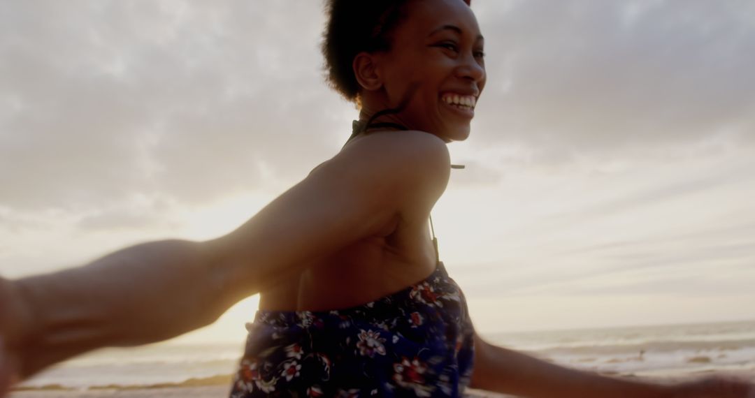 Joyful Lady Running on Beach at Sunset, Carefree and Smiling