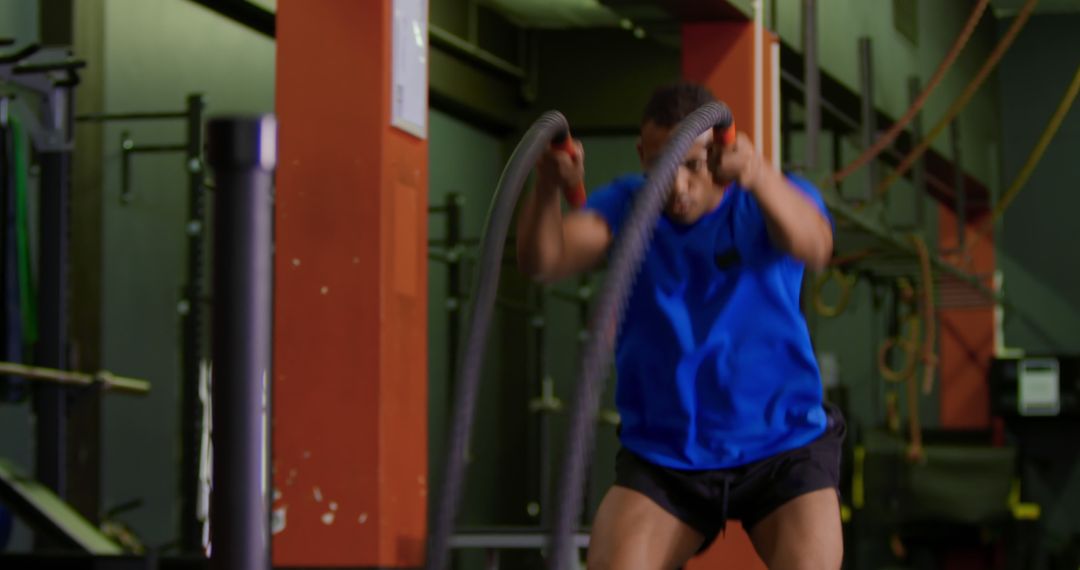 Focused Athlete Using Battle Ropes for Intense Gym Workout - Free Images, Stock Photos and Pictures on Pikwizard.com