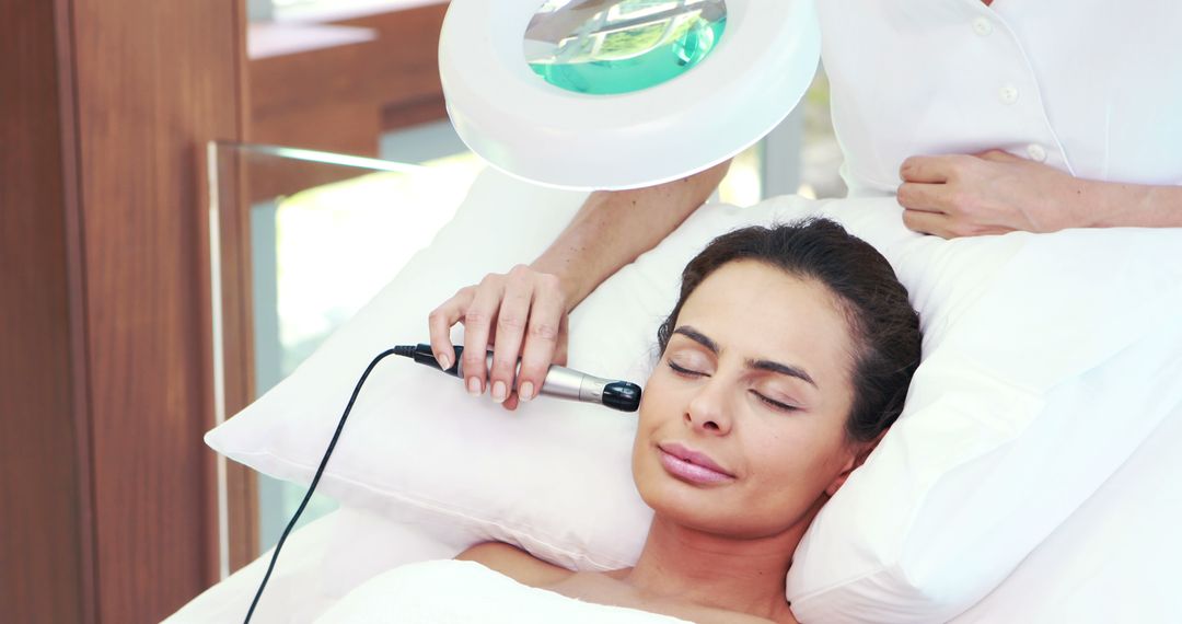 A middle-aged Caucasian woman is receiving a facial treatment from a beautician, with copy space - Free Images, Stock Photos and Pictures on Pikwizard.com