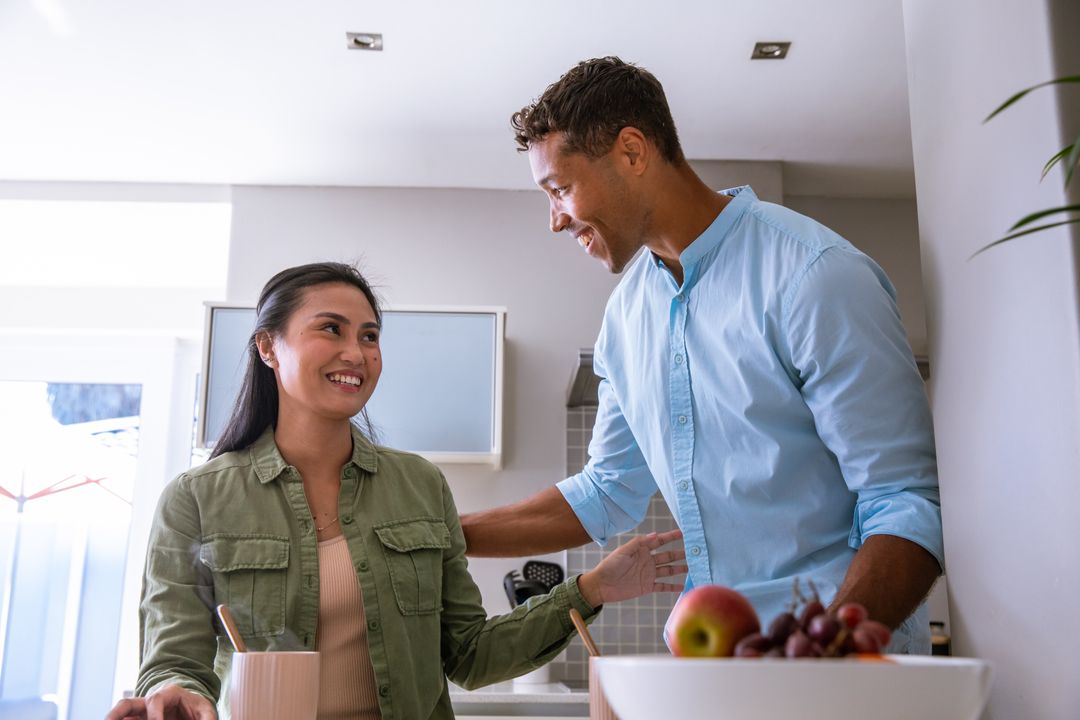 Smiling Couple Enjoying Time in Modern Kitchen Setting