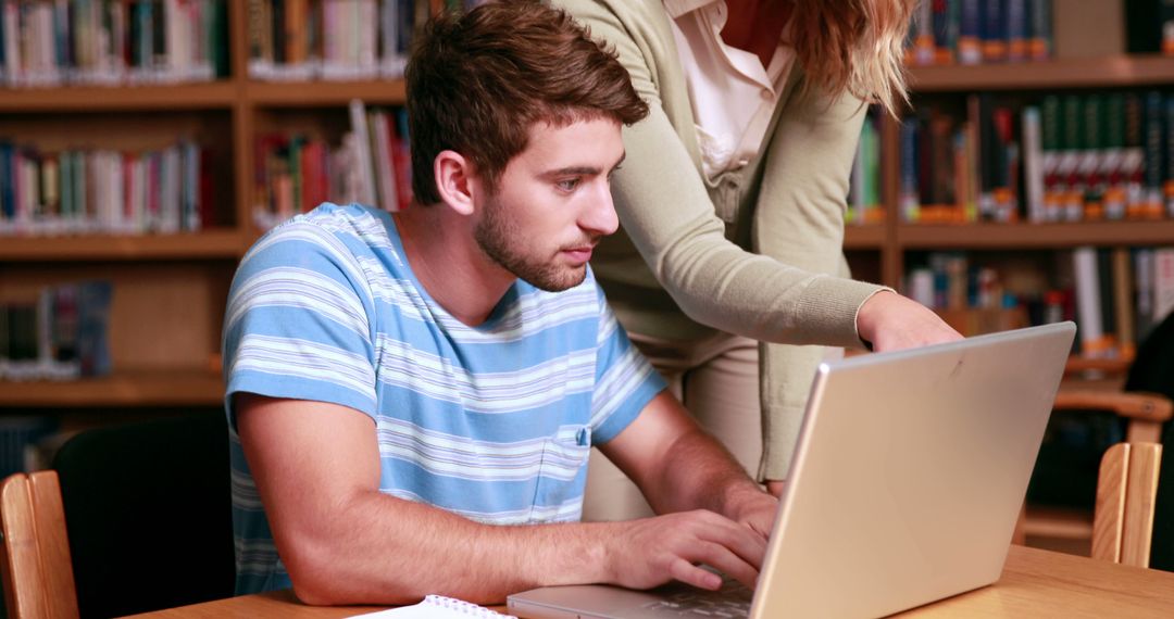 Young Student Receiving Academic Help in Library - Free Images, Stock Photos and Pictures on Pikwizard.com