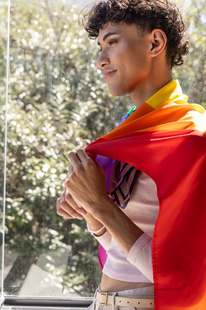 Confident Man Embracing Identity with Rainbow Pride Flag