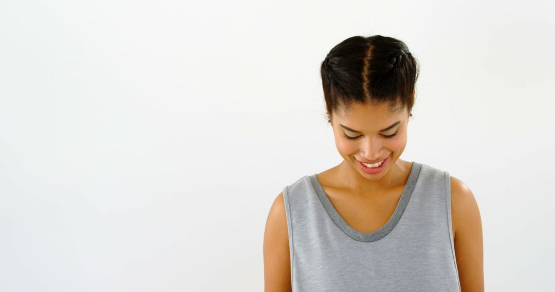 Smiling Woman in Casual Grey Tank Top against White Background - Free Images, Stock Photos and Pictures on Pikwizard.com