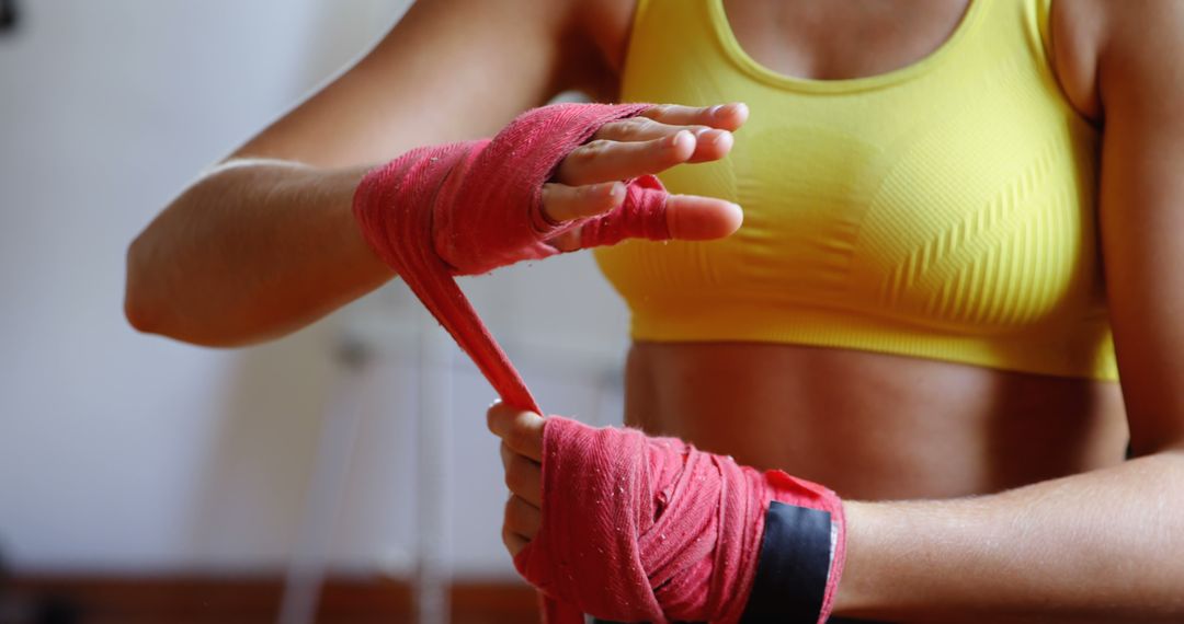 Woman Wrapping Hands in Boxing Wraps at Gym - Free Images, Stock Photos and Pictures on Pikwizard.com