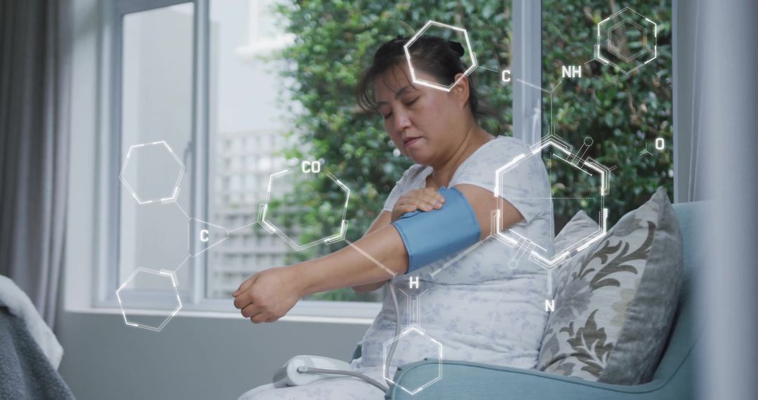 Asian Woman Monitoring Blood Pressure with Digital Interface Concept