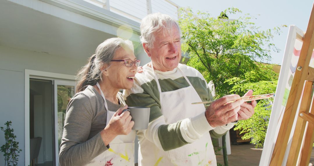 Senior Couple Enjoying Painting Outdoors on a Sunny Day - Free Images, Stock Photos and Pictures on Pikwizard.com