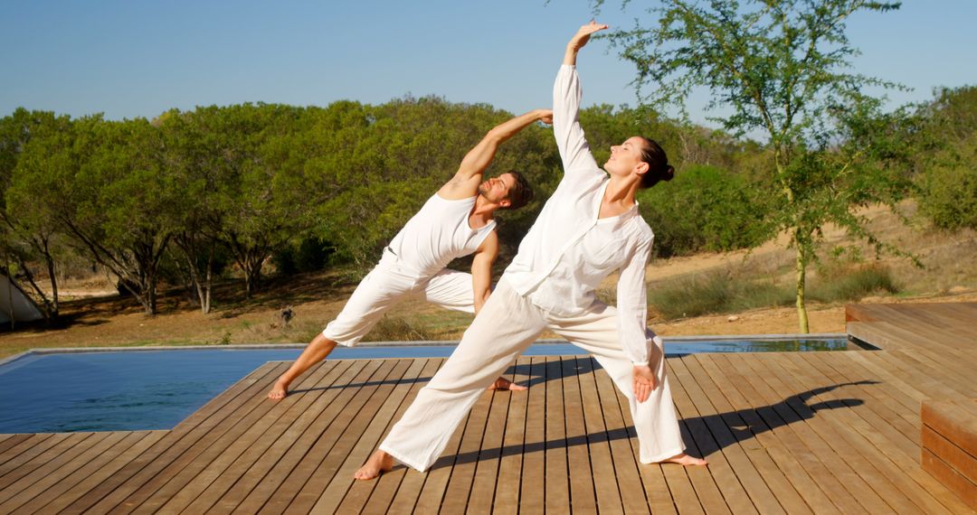 Couple Practicing Yoga Outdoors Near Pool on Wooden Deck - Free Images, Stock Photos and Pictures on Pikwizard.com