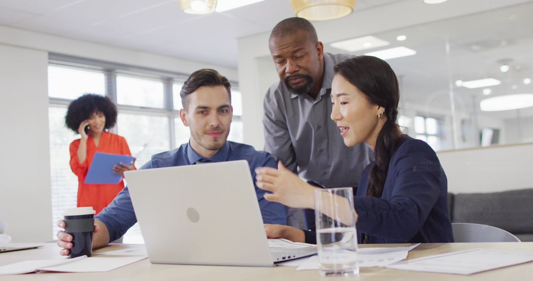 Diverse Team Collaborating on Office Project at Computer