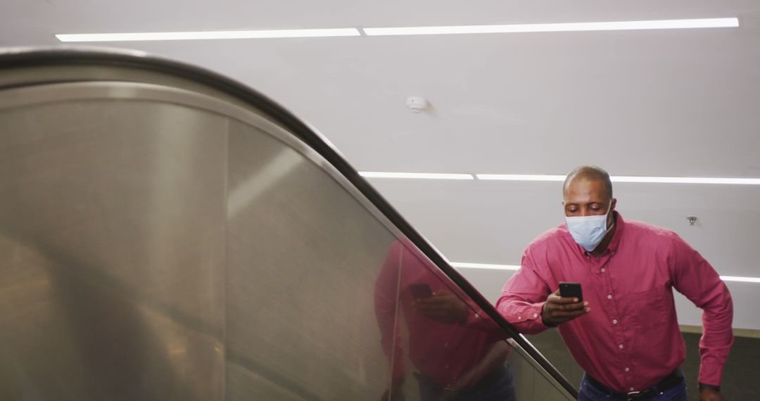 Businessman Riding Escalator and Checking Smartphone - Free Images, Stock Photos and Pictures on Pikwizard.com