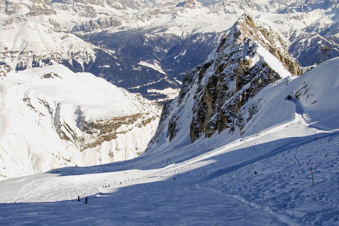 Skiers Enjoying Snowy Alpine Slope on Clear Winter Day - Free Images, Stock Photos and Pictures on Pikwizard.com