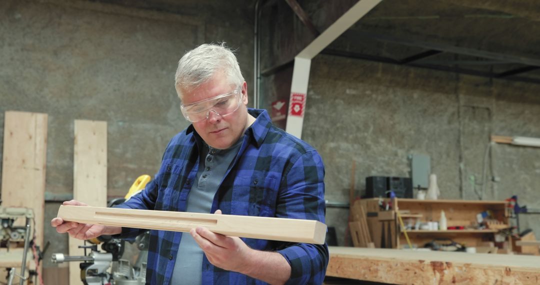 Adult Male Carpenter Inspecting Wooden Plank in Workshop - Free Images, Stock Photos and Pictures on Pikwizard.com