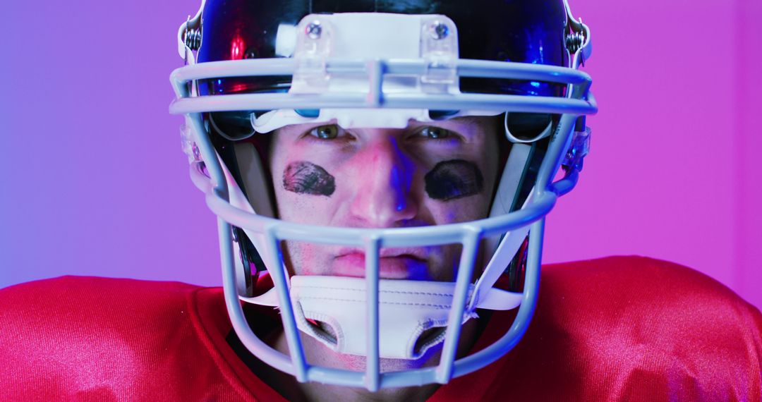Image of portrait of caucasian american football player in helmet over neon purple background - Free Images, Stock Photos and Pictures on Pikwizard.com