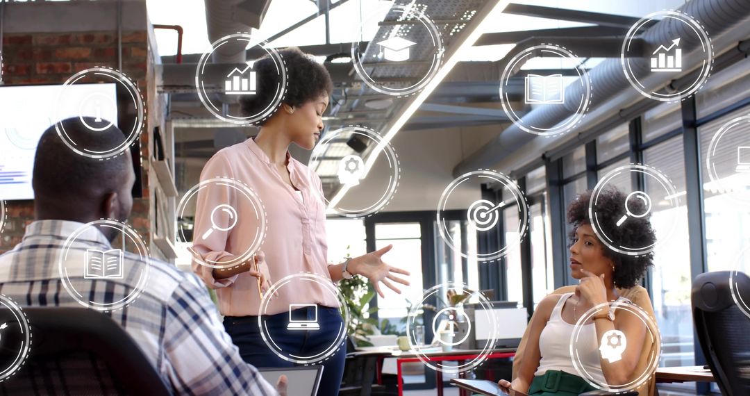 Team presenting and collaborating in modern industrial office with floating data icons