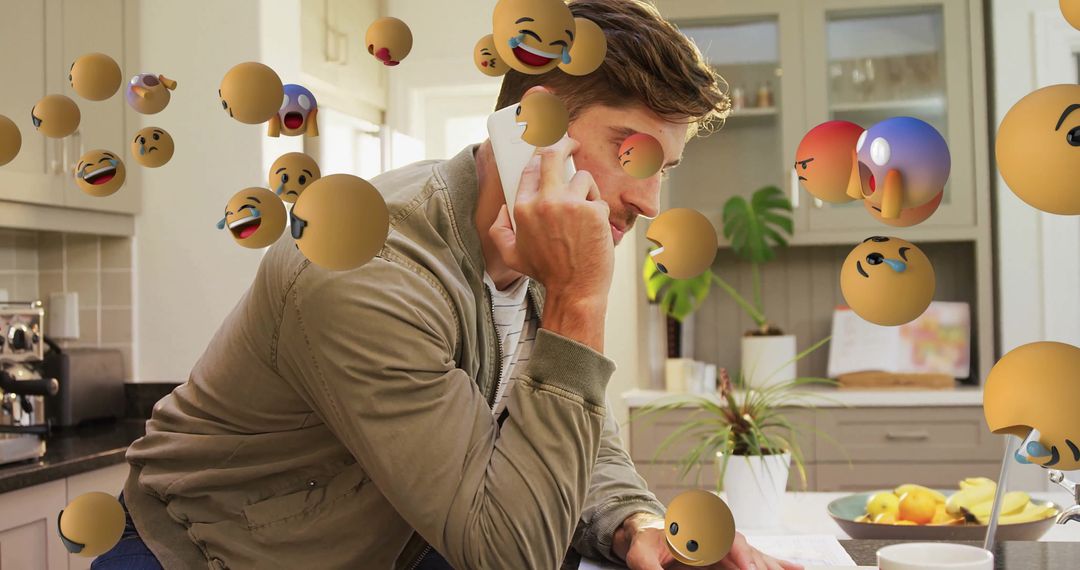 Man using Smartphone with Floating Emojis in Modern Kitchen