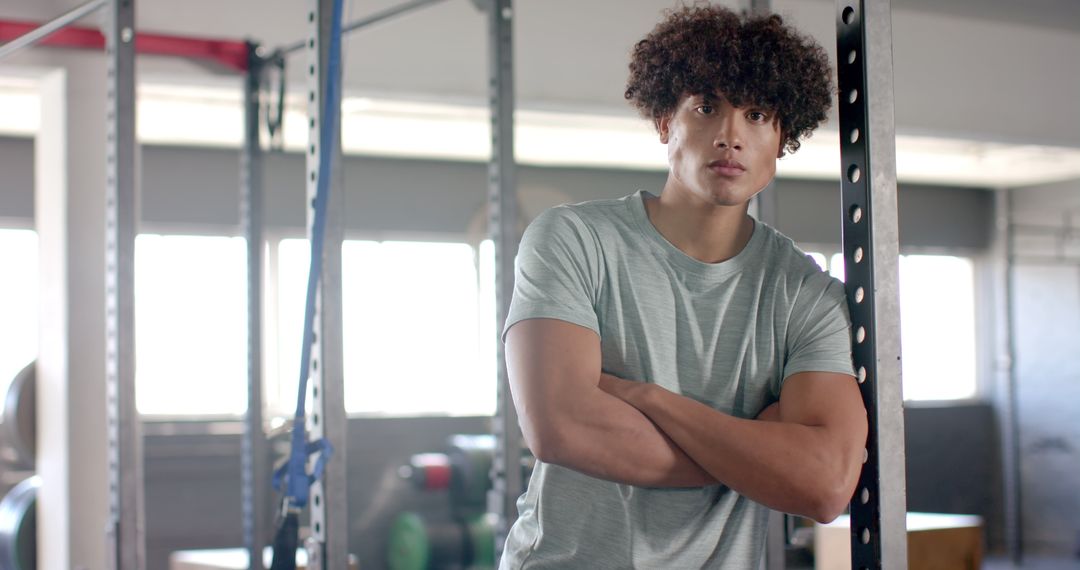 Confident Young Man Relaxing in Modern Gym Environment