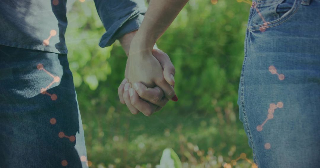 Couple Holding Hands in Garden Wearing Denim