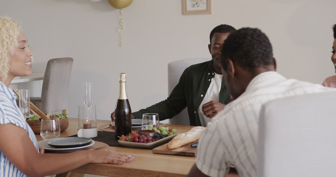 Friends Enjoying Wine and Food at Dining Table