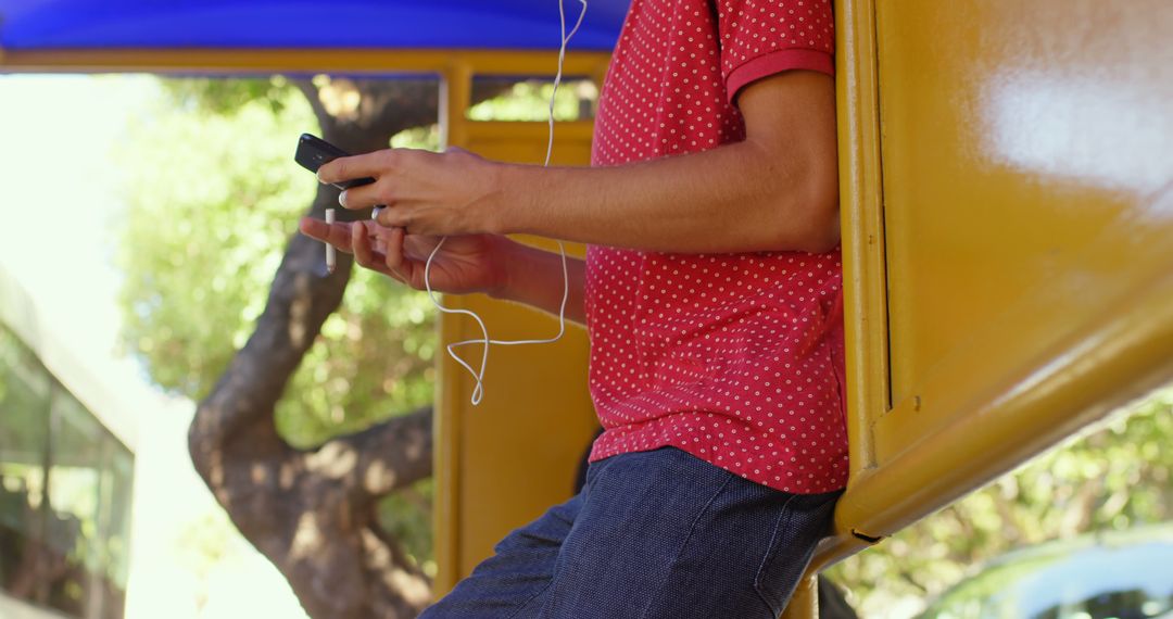 Teen Wearing Headphones and Using Smartphone - Free Images, Stock Photos and Pictures on Pikwizard.com