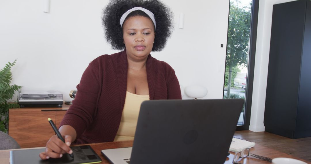 Focused Plus Size Woman Using Laptop for Work at Home