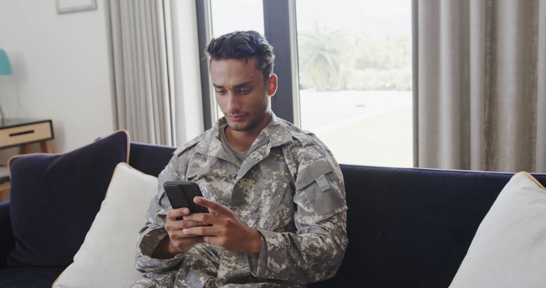 Army Soldier Relaxing at Home Checking Smartphone