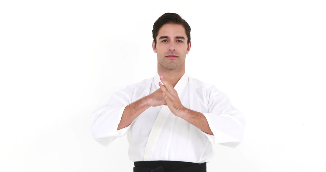 A young Caucasian male martial artist is dressed in a traditional white karate gi, with copy space - Free Images, Stock Photos and Pictures on Pikwizard.com