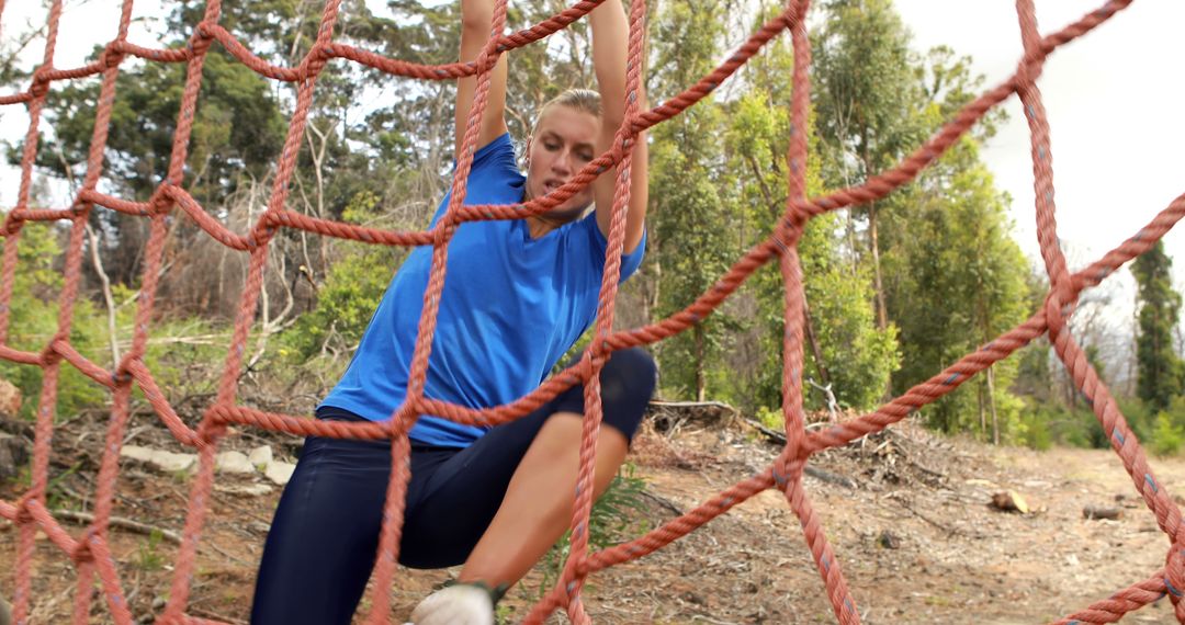 Woman Climbing Net During Outdoor Obstacle Course - Free Images, Stock Photos and Pictures on Pikwizard.com