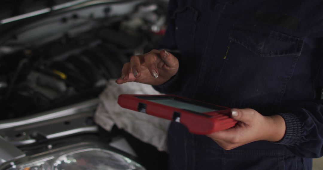 Technician Diagnosing Car Engine with Digital Tablet in Auto Repair Shop - Free Images, Stock Photos and Pictures on Pikwizard.com