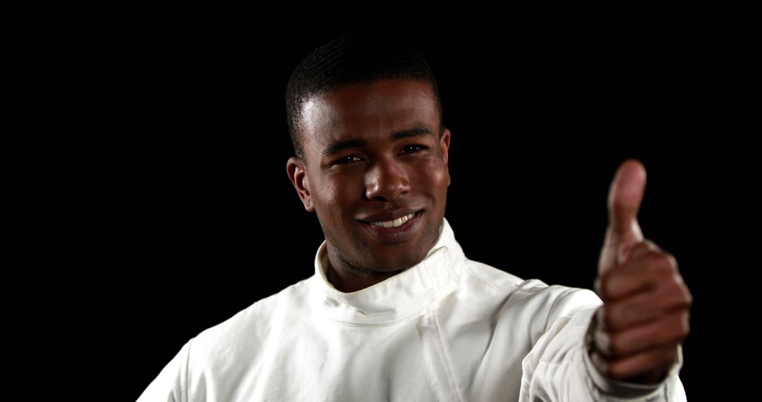 Confident African American Man Giving Thumbs Up in White Outfit - Free Images, Stock Photos and Pictures on Pikwizard.com