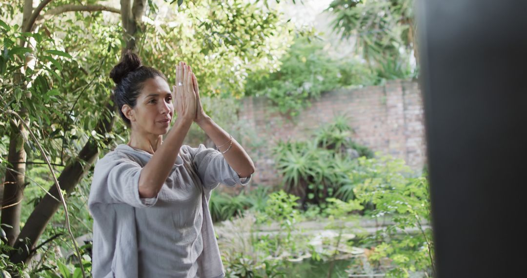 Biracial Woman Engaging in Yoga Outdoors Amidst Lush Greenery - Free Images, Stock Photos and Pictures on Pikwizard.com