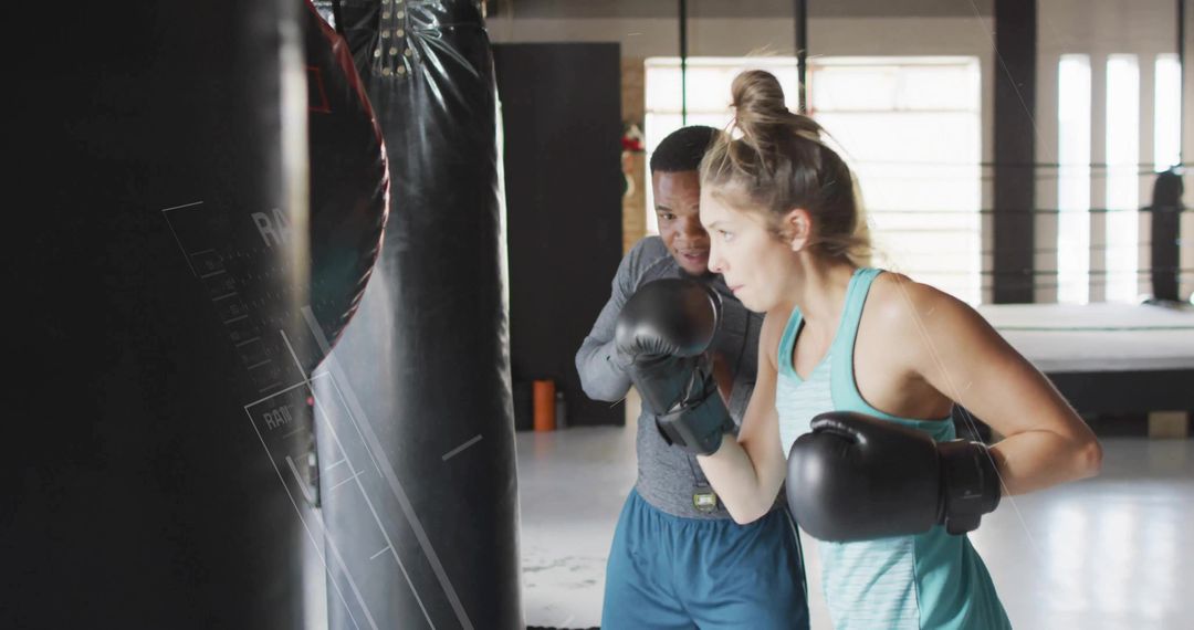 Focused Boxing Training Session with Punching Bag in Gym