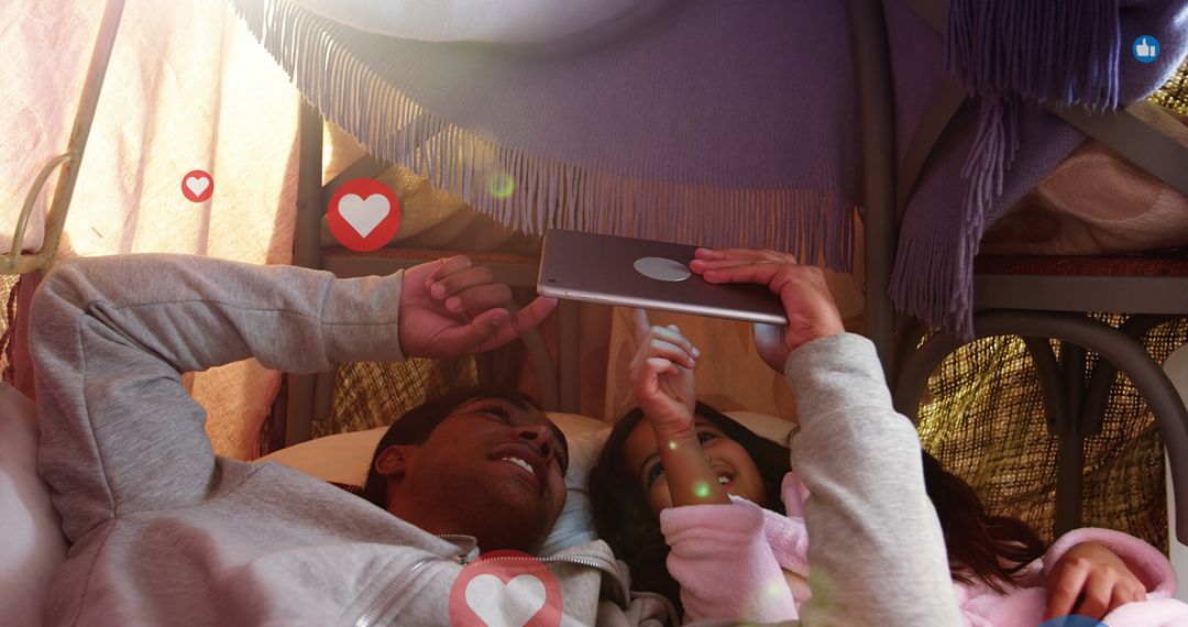 Father and Daughter Bonding with Tablet in Cozy Tent
