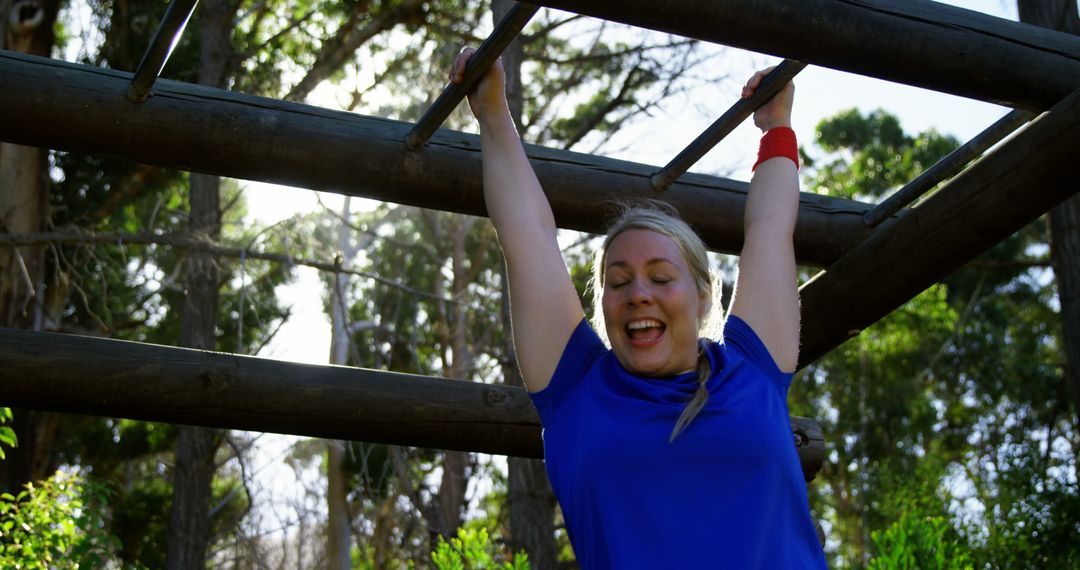 Woman Exercising on Monkey Bars in Sunlit Park - Free Images, Stock Photos and Pictures on Pikwizard.com