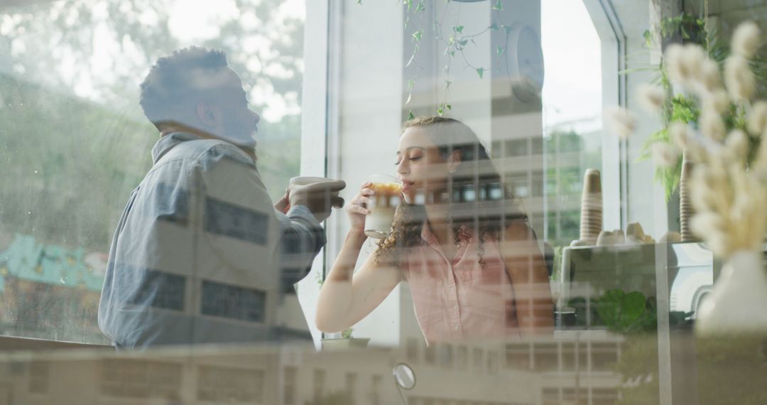Smiling Diverse Couple Enjoying Coffee Date in Bright Cafe
