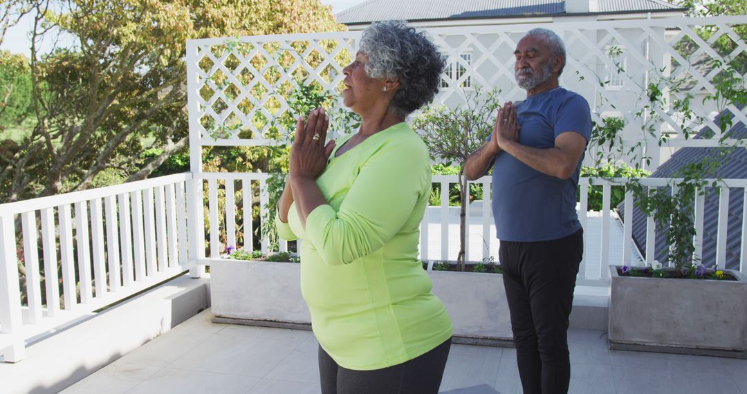 Image of relaxed african american senior couple practicing yoga on patio - Free Images, Stock Photos and Pictures on Pikwizard.com
